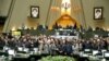 Iranian lawmakers holding pictures of slain Iran's Quds Force leader Qasem Soleimani as they chant 'death to America', during a parliament session in Tehran, January 7, 2020