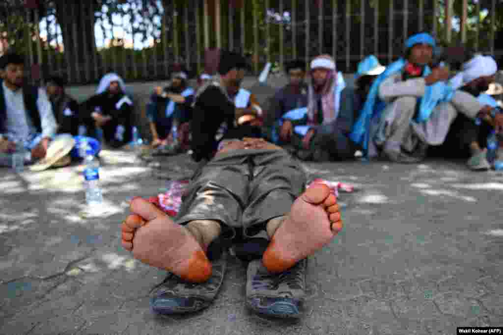 Afghan peace activists rest in Kabul after a peace march. Dozens of activists arrived in Kabul on June 18 after walking hundreds of kilometers across war-battered Afghanistan as the Taliban ended an unprecedented cease-fire and resumed attacks in parts of the country. (AFP/Wakil Kohsar)