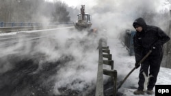 Burning tires are prepared in an effort to block the international E40 highway in Ukraine.