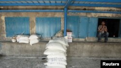 A man sits at a UN food distribution center at a refugee camp in Gaza City.