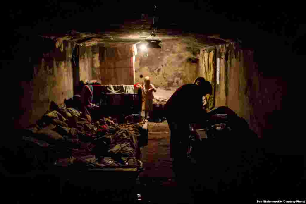 Several local families are living in a bomb shelter in the Petrovskiy district of Donetsk. Their houses were destroyed by shelling. 