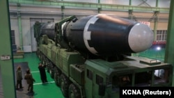 SOUTH KOREA -- FILE PHOTO: North Korea's leader Kim Jong Un is seen as the newly developed intercontinental ballistic rocket Hwasong-15Õs test was successfully launched, in this undated photo released by North Korea's Korean Central News Agency (KCNA) in