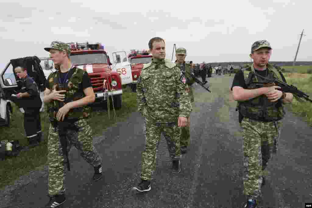 The pro-Russian self-styled governor of the breakaway Donetsk republic Pavel Gubarev (center) arrives to inspect one of the main crash sites.