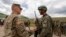 KOSOVO -- A U,S, soldier (L) chats with a soldier of the Kosovo Security Force (KSF), following the 'Defender Europe 21' military exercise in the village of Deve, May 28, 2021