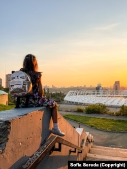 Sereda's daughter takes a break during one of their photo walks around Kyiv before Russia launched its full-scale invasion of Ukraine.