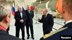 Vlagyimir Putyin és Aljakszandr Lukasenka a Roszkoszmosz főigazgatójával a Vosztocsnij űrrepülőtéren 2022. április 12-én