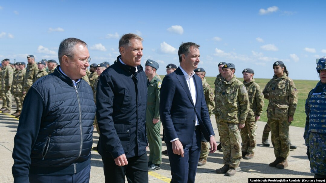 Premierul Nicolae Ciucă (stânga), președintele Klaus Iohannis și prim-ministrul Belgiei, Alexander de Croo, la Baza 57 Aeriană Mihail Kogălniceanu.