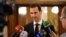 Syrian President Bashar al-Assad speaks to reporters after a meeting with Russian Deputy Prime Minister Dmitry Rogozin in Damascus on December 18. (file photo)