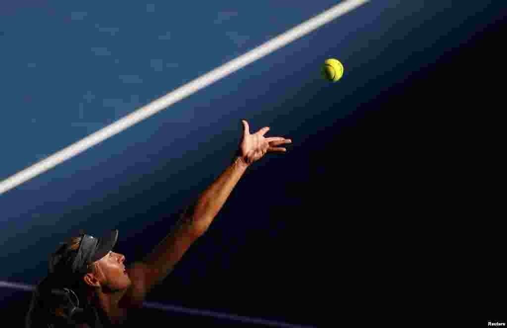 Maria Sharapova of Russia serves to compatriot Ekaterina Makarova during their women&#39;s singles quarter-final match at the Australian Open tennis tournament in Melbourne. (Reuters/David Gray)