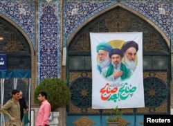 People stand at the Tehran Bazaar Central Mosque on April 13.