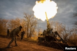 Ukrainian servicemen fire a 2S7 Pion self-propelled gun at a Russian position on the front line in the Kherson region on November 9.