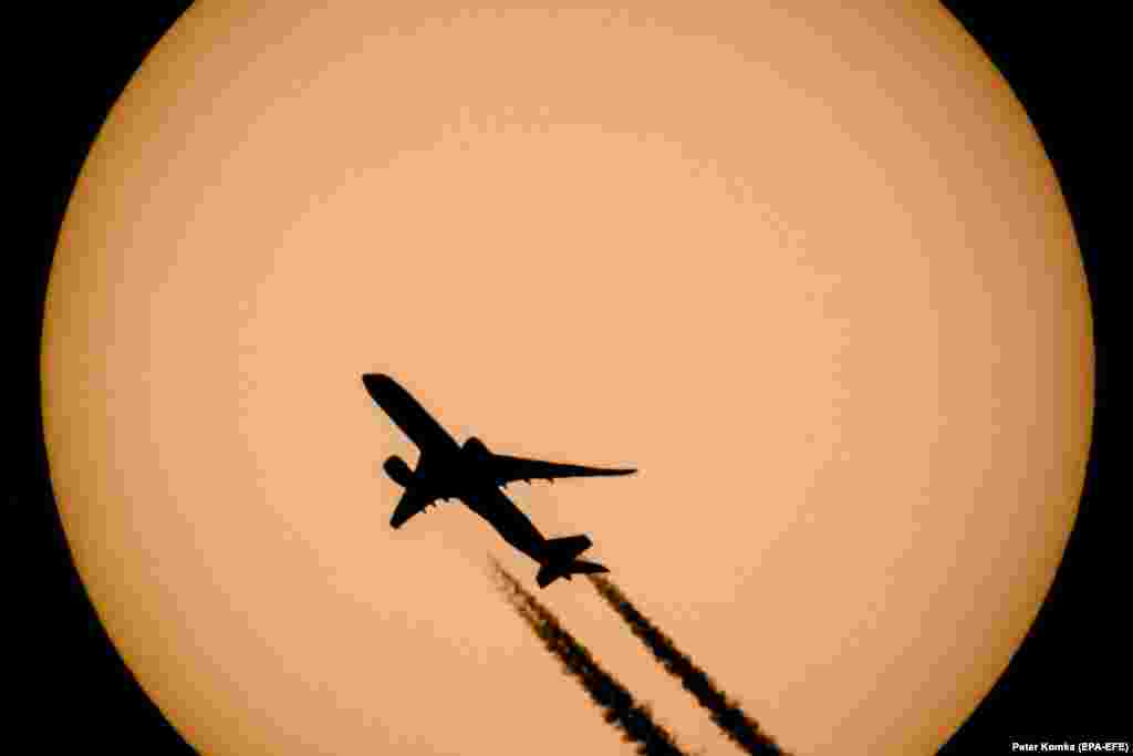 A passenger plane passes in front of the sun in Vizslas, Hungary.&nbsp;