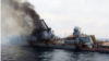 A photo shared on social media and widely believed to show the Moskva on fire and listing badly.
