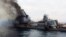 Moskva warship -- A photo shared on social media and widely believed to be the Moskva shows it on fire and listing badly. April 2022
