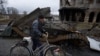 A man with his bike in the Bucha region, Ukraine