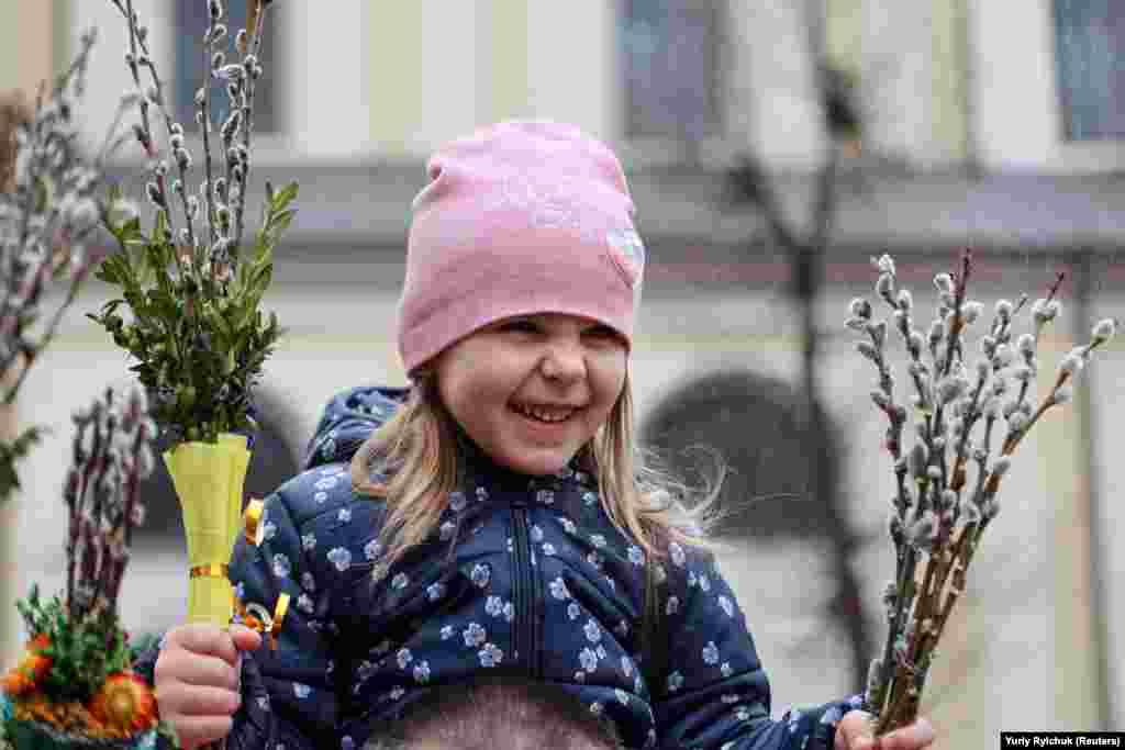 A young girl holds willow branches at a Palm Sunday celebration in Ivano-Frankivsk on April 17.