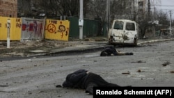 The bodies of men dressed in civilian clothes lie on a street in Bucha, northwest of Kyiv, on April 2.