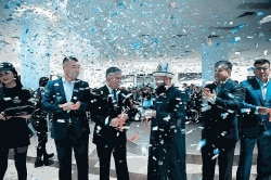 Kanybek Tumanbaev (second from left), former Grand Mufti Maksatbek Toktomushev (third from right), and parliamentary deputy Ravshan Sabirov (second from right) at the opening of the Black Star Burger chain in March 2019.