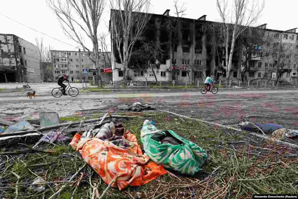 The bodies of Ukrainian civilians killed by Russian shelling lay by a roadside in the southern port city of Mariupol.