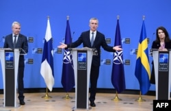 NATO Secretary-General Jens Stoltenberg (center) is flanked by Finnish Foreign Minister Pekka Haavisto (left) and Sweden Foreign Minister Ann Linde after a joint meeting at NATO headquarters in Brussels on January 24.