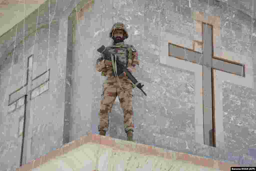 A Frontier Constabulary guard stands watch during an Easter Sunday Mass at the Bethel Memorial Methodist Church in Quetta, Pakistan.