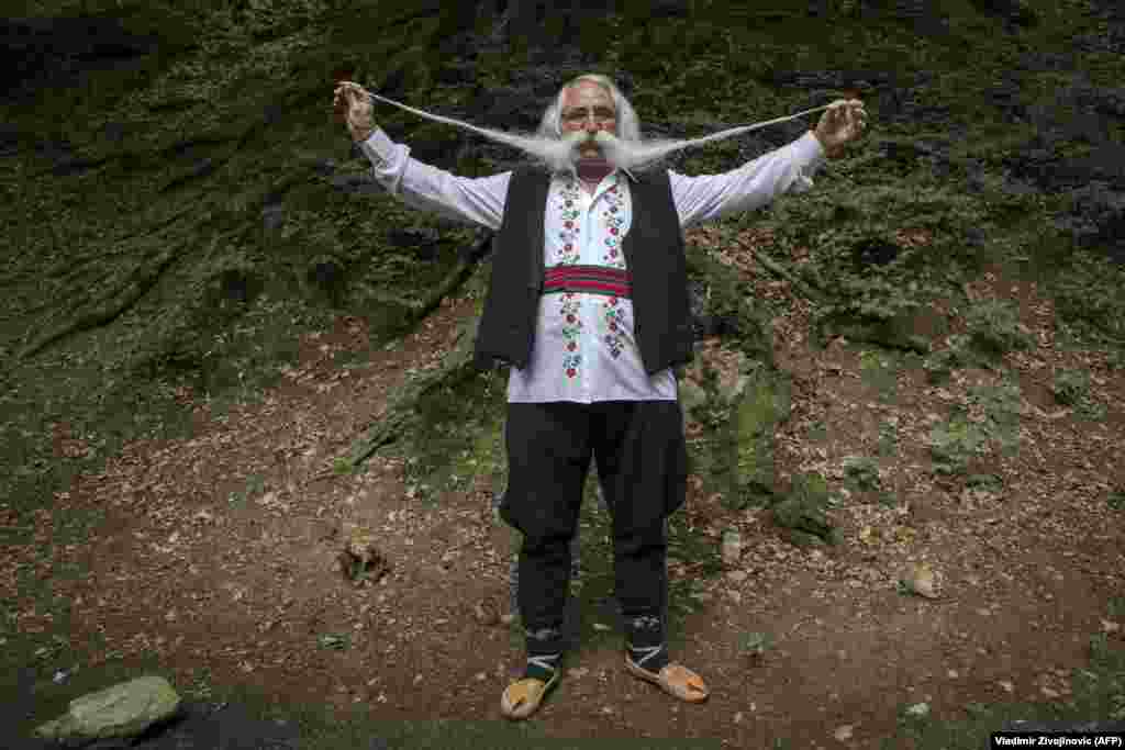 Zoran Lazarevic, 70, shows off his mustache as he takes part in the longest mustache competition at the 15th-century Kalenic Serbian Orthodox monastery, near Rekovac in central Serbia. Lazarevic won the competition with his 140-centimeter mustache. (AFP/Vladimir Zivojinovic)