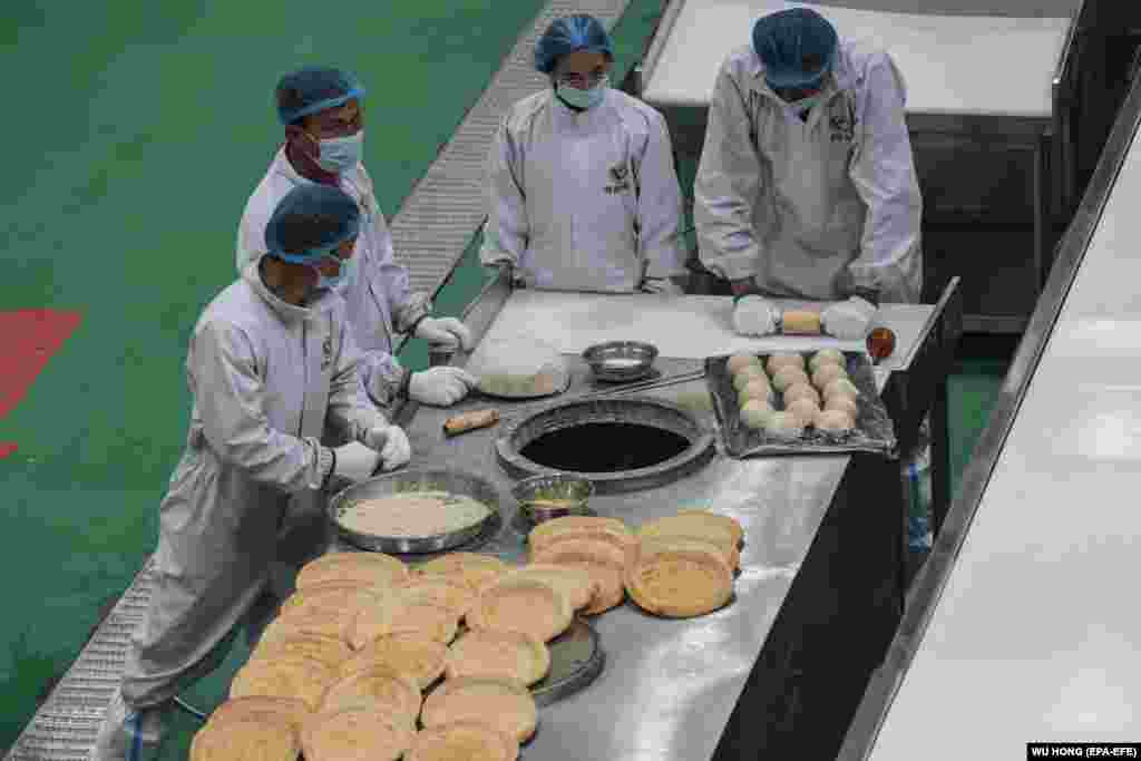 CHINA XINJIANG FOOD -- Workers make nang in a nang food production base at in Urumqi, western China's Xinjiang Uyghur Autonomous Region during a government organized trip for foreign journalists, 23 April 2021. This production base has as many as 1,200 wo