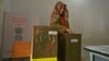A voter casts her ballot during the first phase of local elections in Kashmir on November 28. 