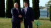 Hungarian Prime Minister Viktor Orban (left) and Kyrgyz President Sooronbai Jeenbekov shake hands on September 3.