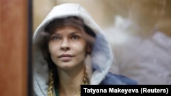 Anastasia Vashukevich, also known as Nastya Rybka, sits inside a defendants' cage before a court hearing in Moscow on January 19.