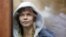Anastasia Vashukevich, also known as Nastya Rybka, sits inside a defendants' cage before a court hearing in Moscow on January 19.