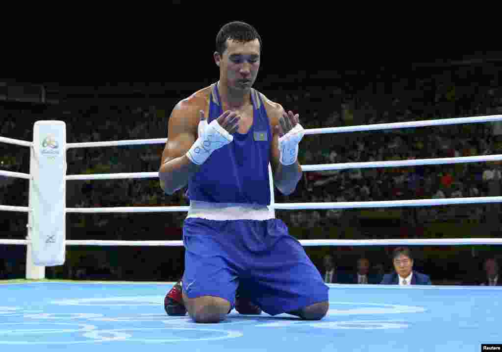 Adilbek Niyazymbetov of Kazakhstan prays on the ring before competing in the light heavyweight boxing final.&nbsp;He took home silver after being defeated by Cuban Julio Cesar La Cruz.&nbsp;