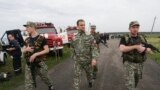 Ukraine -- The pro-Russian self-proclaimed governor of the Donetsk region Paul Gubarev (C) looks at debris of the Boeing 777, Malaysia Arilines flight MH17, which crashed during flying over the eastern Ukraine region near Donetsk, July 18, 2014