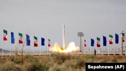 An Iranian rocket carrying a satellite is launched from an undisclosed site believed to be in the Semnan Province on April 22.