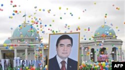 People carry a giant portrait of President Gurbanguly Berdymukhammedov during Turkmenistan's Independence Day celebrations in Ashgabat last October.