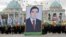 Crowds carry a giant portrait of President Gurbanguly Berdymukhammedov during Turkmen Independence Day celebrations in Ashgabat on October 27, 2009.
