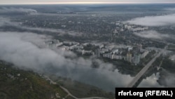 Vedere din partea dreaptă a Nistrului asupra podului peste râu și a orașului Râbnița, unde se află unul din cei mai mari agenți economici din regiunea transnistreană, Uzina Metalurgică (în depărtare)