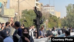 Protesters rally in Tehran on October 2. Iran has seen a rare outburst of sustained public anger, driven in large part by women.