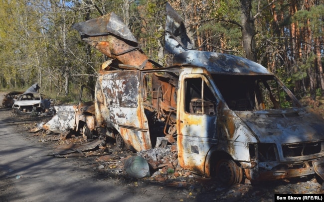 Gutted vehicles along a road into Lyman on October 9.