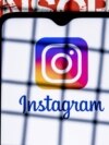 Oct 21, 2021: Instagram social network logo on the smartphone screen behind the bars on the background with the inscription censored.