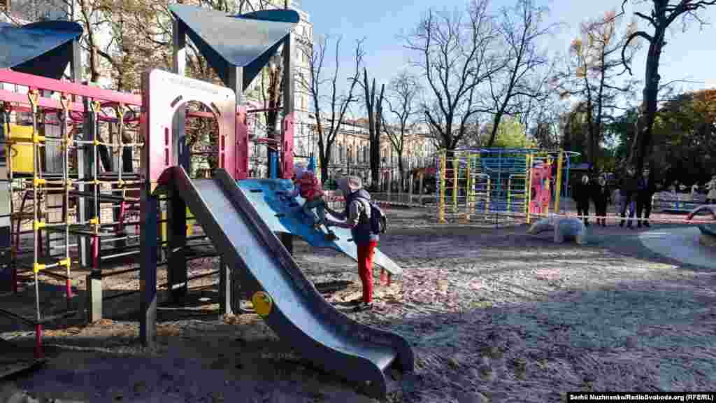 A Ukrainian child returns to the playground in Taras Shevchenko Park a day after the deadly attack.