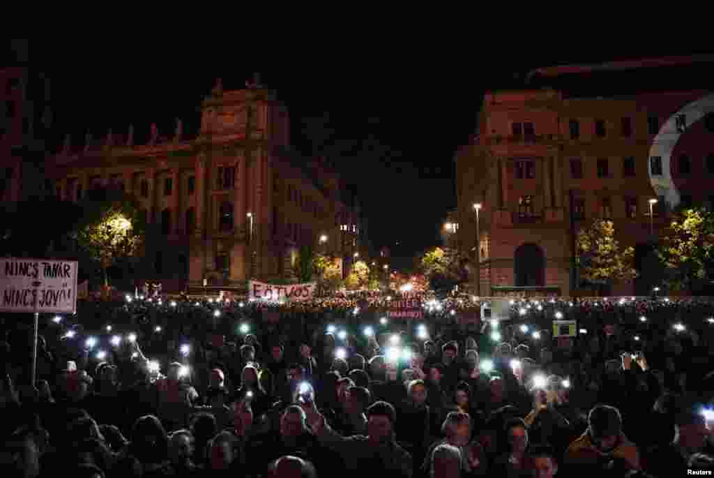 Hungarian demonstrators light up their cell phones during a rally in Budapest in support of teachers fighting for higher wages and teachers who have been fired for protesting.&nbsp;
