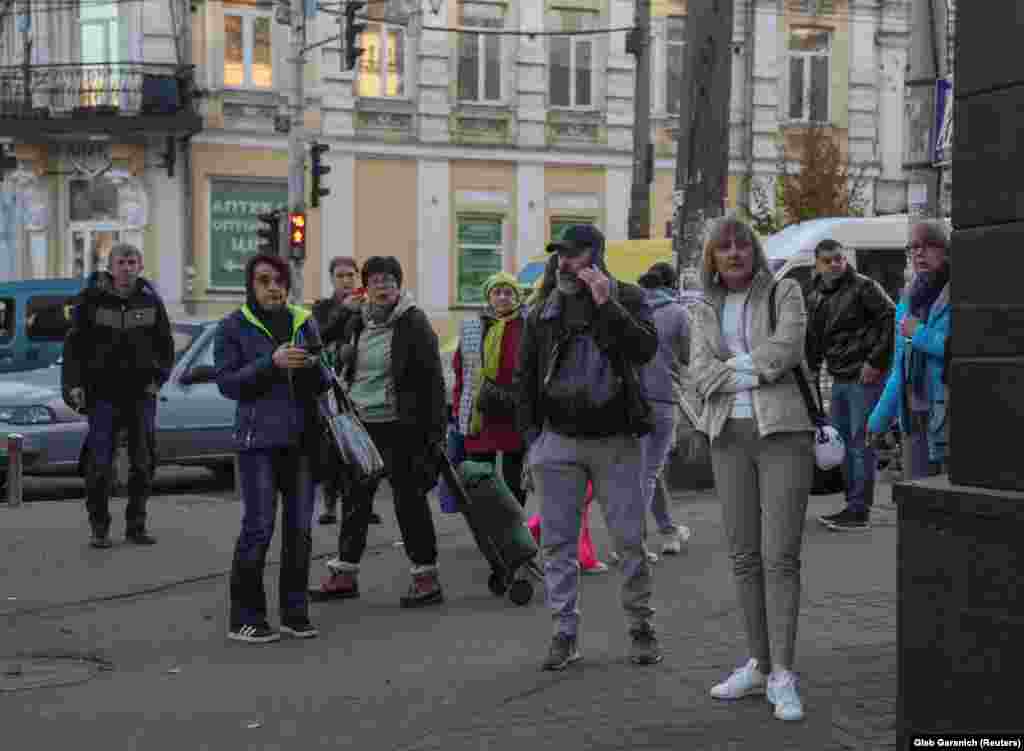 Local residents look on after a Russian drone strike in Kyiv.&nbsp; &nbsp;