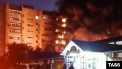 An apartment building catches fire after a Sukhoi Su-34 aircraft crashed into it on October 17.