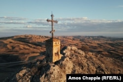 A mountaintop cross of the St. Elias Monastery, a famous landmark of Georgia's livestock migration route.