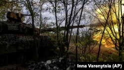 A Ukrainian T-64 tank fires at Russian positions in Bakhmut, Ukraine, on October 2.
