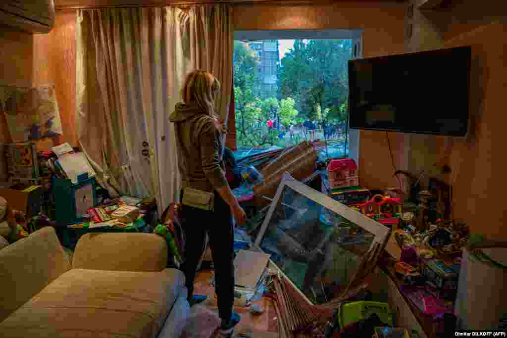A woman stands in her shattered apartment in Dnipro. NATO chief Jens Stoltenberg and European allies criticized Russia&#39;s &quot;horrific&quot;&nbsp;wave of air strikes. &nbsp;