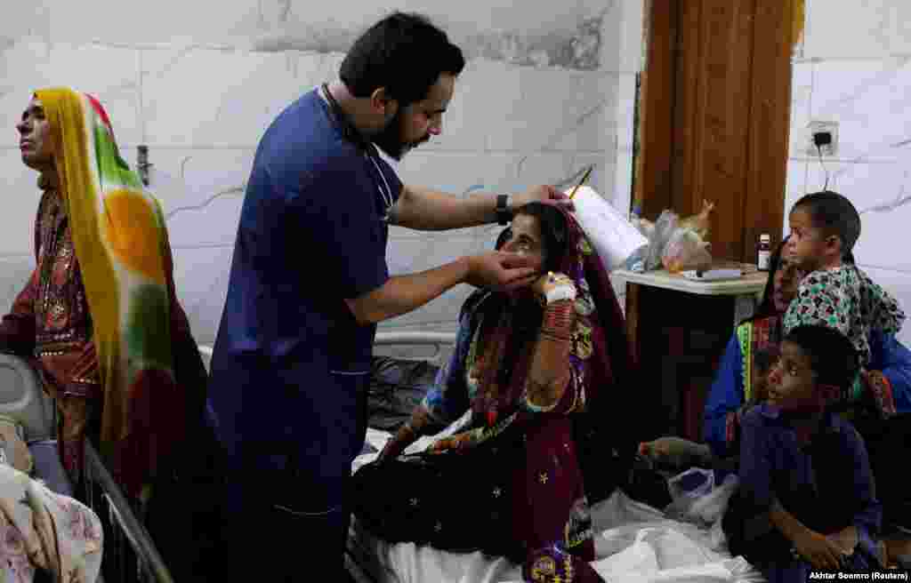 Dr. Naveed Ahmed checks a girl suffering from malaria at the Sayed Abdullah Shah Institute of Medical Sciences in Sehwan on September 29. Most of the estimated 300-400 patients arriving at the clinic each morning are suffering from malaria and diarrhea. With winter approaching, Ahmed fears other illnesses will become more common. &quot;I hope people displaced by the floods can get back to their homes before winter. [Otherwise,] they will be exposed to respiratory illnesses and pneumonia living in tents,&quot; he said.