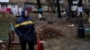 An elderly woman cries near her house in Bucha, northwest of Kyiv, on April 2. The town's mayor said 280 people had been buried in a mass grave and that the town was littered with corpses.