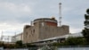 Septembrie 2022: blandate rusești în fața centralei nucleare ucrainene de la Zaporojie, în cursul misiunii internaționale de inspecție a AIEA, Energodar, Ucraina, 1 septembrie 2022.